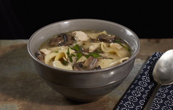 Chicken noodle soup with mushrooms and Parmesan