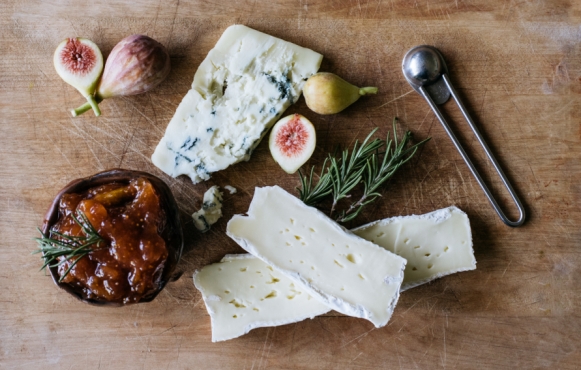 cheese rosemary and fig preserves on a cutting board